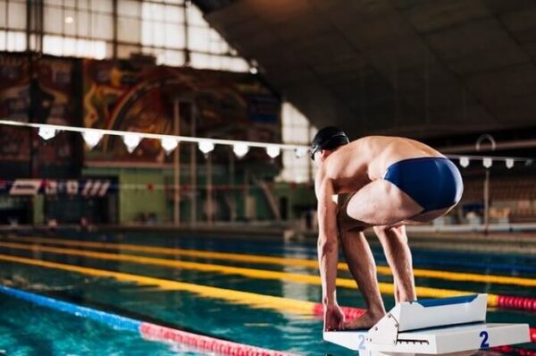 man jump in swimming pool