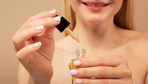 Woman hand holding cbd oil