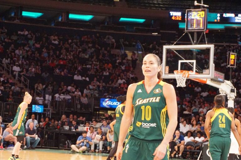 Sue Bird stand in playground